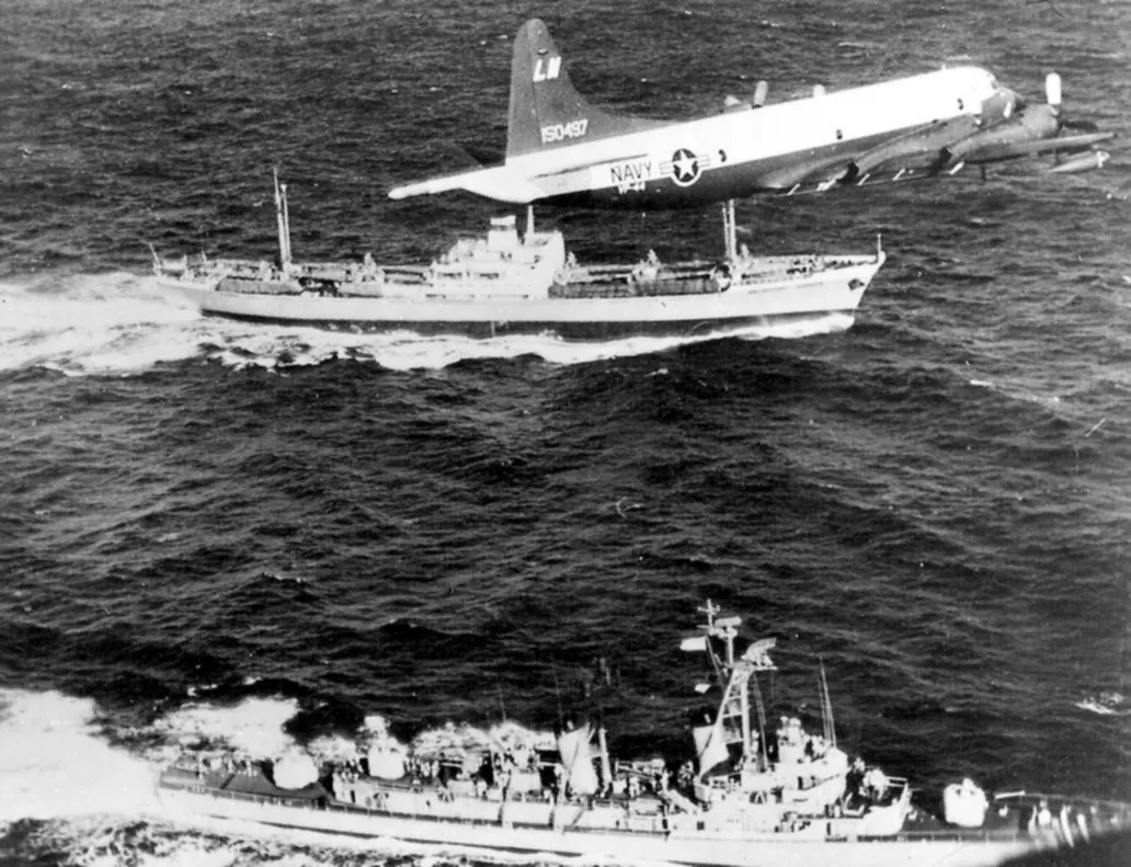 A U.S. Navy P-3 Orion of Patrol Squadron VP-44 over the Soviet freighter Metallurg Anosov and the destroyer USS Barry, November 1962: the naval quarantine off the coast of Cuba, where a single mistake would have cost the world a war.